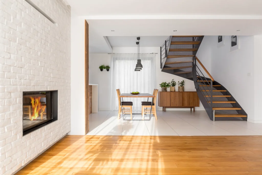 Modern living room with a fireplace and staircase.